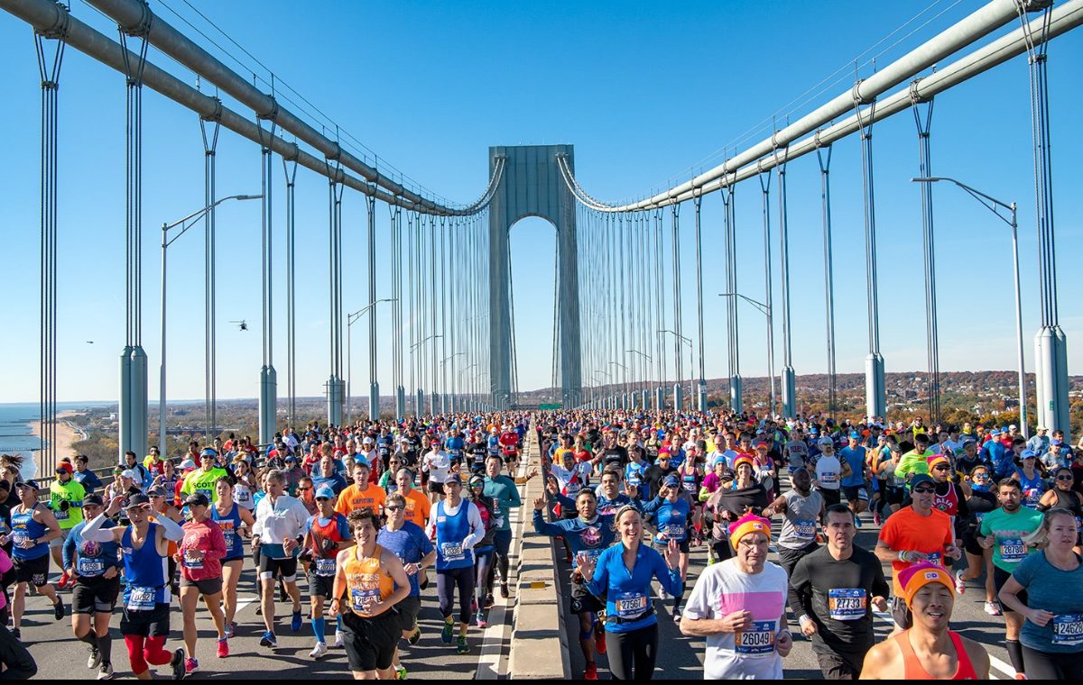 A dense field of runners crossing the Verrazzano-Narrows Bridge at the start of the New York City Marathon.