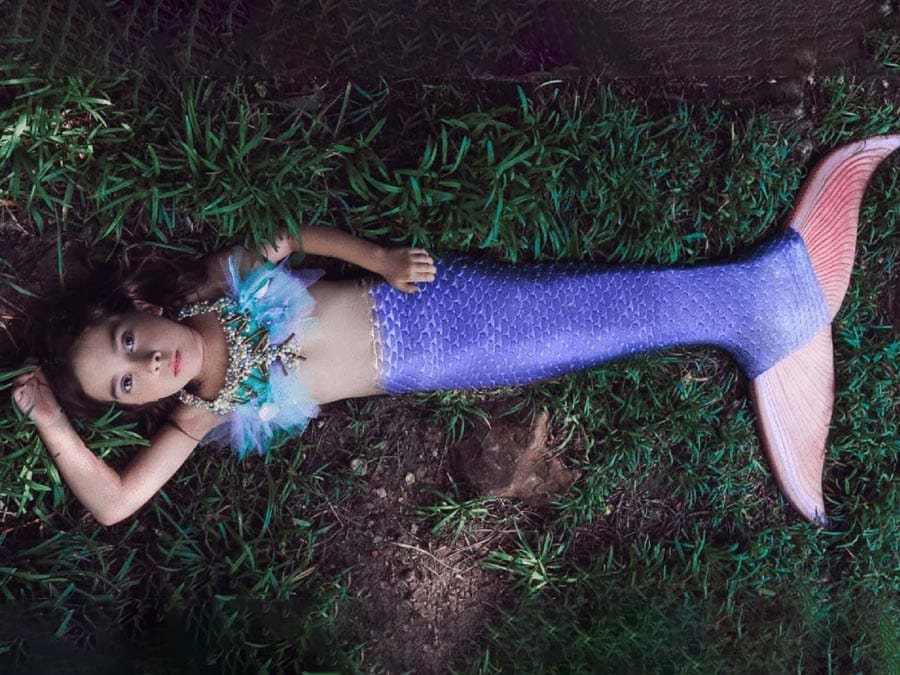 Addie in a colorful mermaid costume.