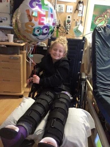 Alana recovering with leg casts after surgery.
