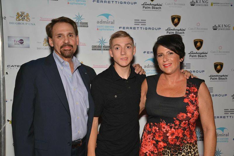 Zach with his parents at a gala.