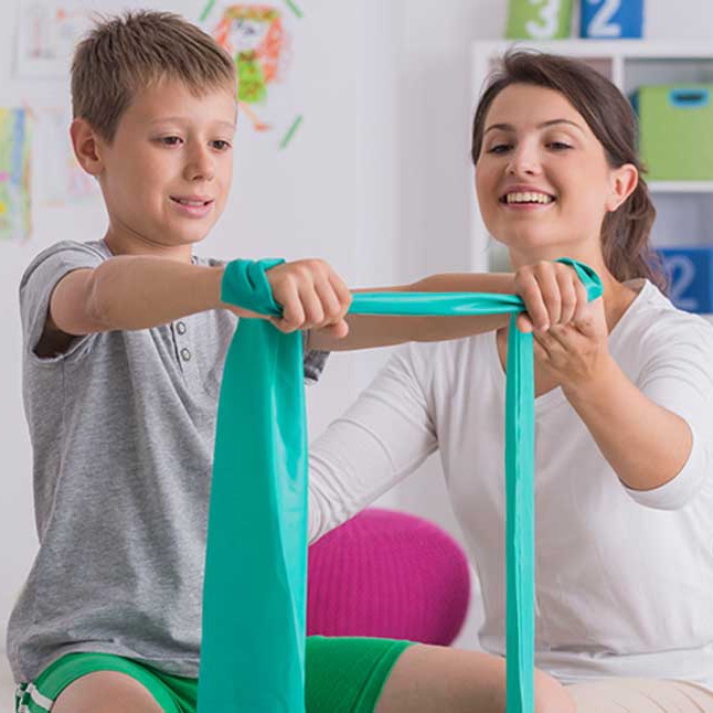 A child working through physical therapy exercises.